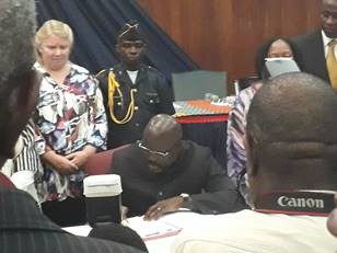 President George Weah signing Land Rights Act